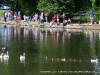 Parents and their children line the shore at the Fairgrounds Pond