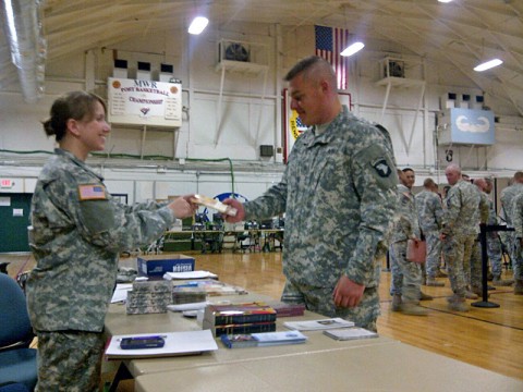 U.S. Army Capt. Delana I. Small, chaplain with Headquarters and Headquarters Company, 4th Battalion, 320th Field Artillery Regiment, 4th Brigade Combat Team, 101st Airborne Division, and a native of Springfield, MS, greets and shares literature with a soldier as part of her religious support duties at Fort Campbell, Ky. Small was assigned as the 101st Airborne Division’s first female chaplain in a combat arms unit as part of the Department of Defense initiative, Women in the Service Review.