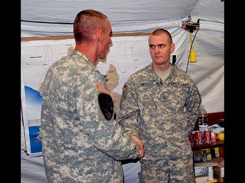 Pfc. Jacob Anderson, a cargo specialist and Murrieta, Calif., native with the 372nd Inland Cargo Transfer Company, 129th Combat Sustainment Support Battalion, 101st Sustainment Brigade, Joint Forces Command – United Assistance, is recognized by Maj. Gen. Gary Volesky, commander of JFC-UA, for his exemplary performance while supporting Operation United Assistance, Jan. 9, 2015, at the Barclay Training Center, Monrovia, Liberia. (Staff Sgt. V. Michelle Woods, 27th Public Affairs Detachment)