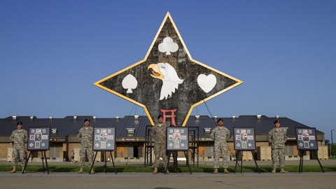 Members of the 101st Special Troops Battalion, 101st Sustainment Brigade, 101st Airborne Division (Air Assault), stand next to photos of five 101st STB Soldiers who were killed during an insider attack at Forward Operating Base Gamberi, Laghman Province, Afghanistan, on April 16, 2011. (Sgt. 1st Class Mary Rose Mittlesteadt, 101st Sustainment Brigade, 101st Airborne Division (Air Assault) Public Affairs)