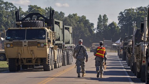 Sgt. Bradley Sims (left) and Spc. Khari Jarvis (right), both movement professionals with the 613th Movement Control Team, 129th Combat Sustainment Support Battalion, 101st Airborne Division Sustainment Brigade (Lifeliners), 101st Airborne Division (Air Assault), walk a line of trucks at the Intermediate Staging Base in Alexandria, La., in preparation for movement to the Joint Readiness Training Center’s (JRTC) training area called the “box” at Fort Polk, La., on Oct. 3, 2015. (Sgt. 1st Class Mary Rose Mittlesteadt, 101st Airborne Division Sustainment Brigade (Lifeliners) Public Affairs)