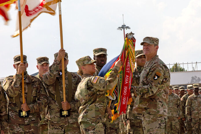 U.S. Army Maj. Gen. JP McGee, right, commanding general, 101st Airborne Division (Air Assault), and Command Sgt. Maj. Veronica Knapp, left, uncase the division colors during a ceremony at Mihail Kog?lniceanu Air Base, Romania, July 30, 2022. The ceremony officially marked the arrival of the Screaming Eagles to the European theater in support of V Corps, America's Forward Deployed Corps, who oversee all rotational forces in Europe. (Spc. Elizabeth MacPherson) 