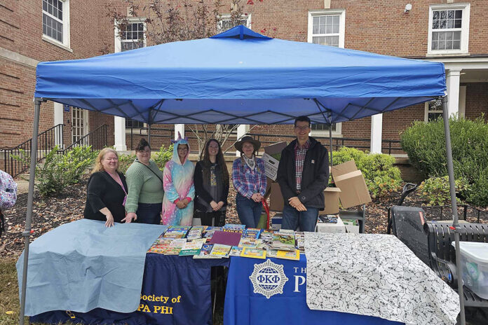 Members of Austin Peay State University’s Phi Kappa Phi chapter prepare to distribute free books to children in the community during their annual Candy for the Mind event. (APSU)
