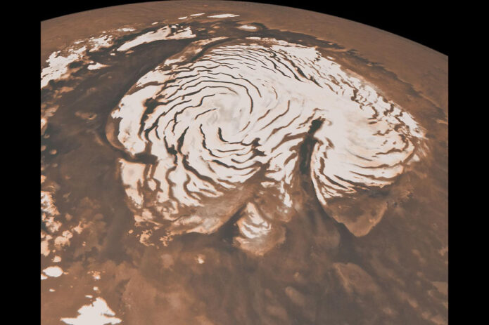 As temperatures rise, powerful winds kick up that carve deep troughs into the ice cap of Mars’ north pole. Some of these troughs are as long as California, and give the Martian north pole its trademark swirls. This image was captured by NASA’s now-inactive Mars Global Surveyor. (NASA/JPL-Caltech/MSSS)