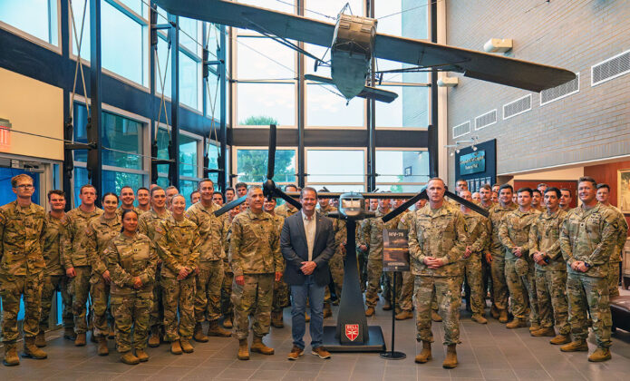Brig. Gen. Travis McIntosh, Deputy Commanding General (Support) of the 101st Airborne Division (Air Assault), and Doug Englen, Chief Warrant Officer 5 (retired) and Bell Senior Military Sales and Strategy Manager, pose with Army Aviators after the official unveiling of the Future Long Range Assault Aircraft (FLRAA) at the 101st Division Headquarters at Fort Campbell, Ky. on June 6, 2025. The FLRAA represents the future of vertical envelopment and is projected to be the next key piece in Army Aviation and the Long Range, Large Scale Air Assault (L2A2) when it is fielded to the 101st in 2028. (Sgt. 1st Class Joshua Joyner, 101st Airborne Division (Air Assault))